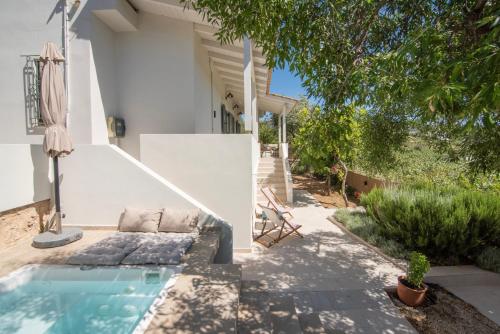 a house with a swimming pool in a yard at Leonti Maison in Egina