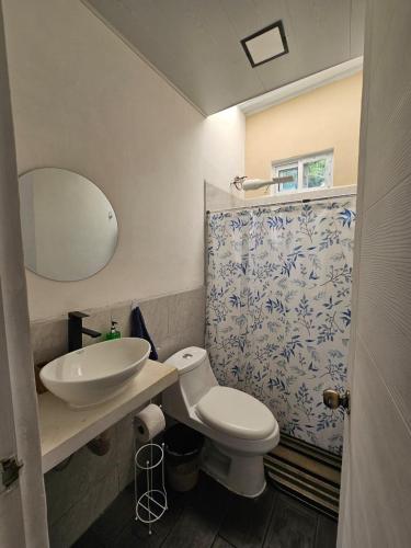 a bathroom with a sink and a toilet and a mirror at Casa Nael a 2Km del IRTRA in San Martín Zapotitlán