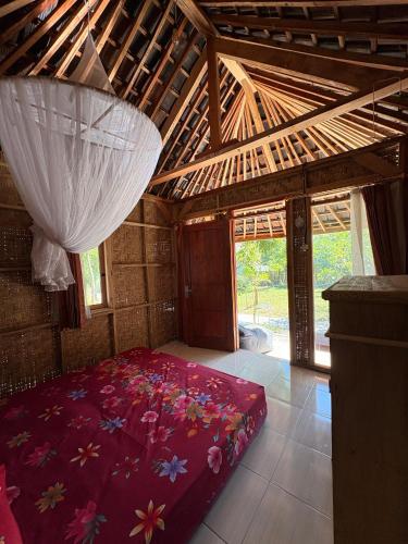 a bedroom with a large bed with flowers on it at Melody Surf Ekas Lombok in Ekas