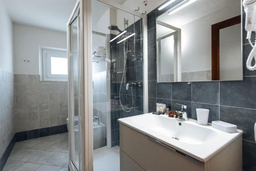 a bathroom with a sink and a shower at Residenza Cavour in Empoli