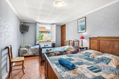 a room with three beds and a tv and a bedskirts at Chambres D'hôtes Des 17 Clochers - in Saint-Vérand