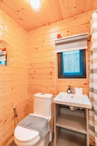 a bathroom with a white toilet and a sink at THUNWA the CAMPSITE in Ban Khao Ya Nua