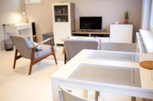 a living room with a white table and chairs at B2B-flats AALST in Aalst
