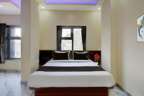 a bedroom with a large bed in a room at Super Collection O MIDC Pimpari Pune Formerly SK Palace in Chinchwad