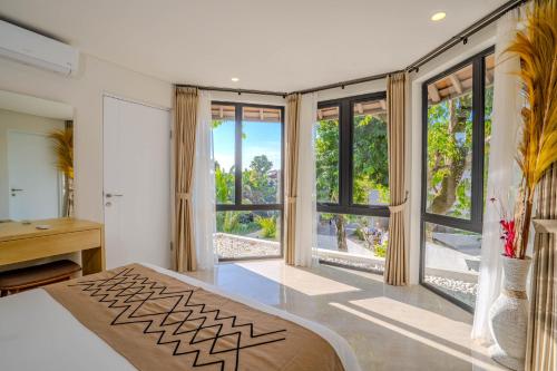 a bedroom with a bed and large windows at Sanara Oasis Villa in Canggu
