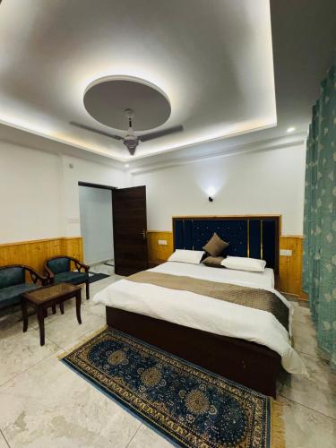 a bedroom with a large bed and a couch at Green tree house in Dharmsāla