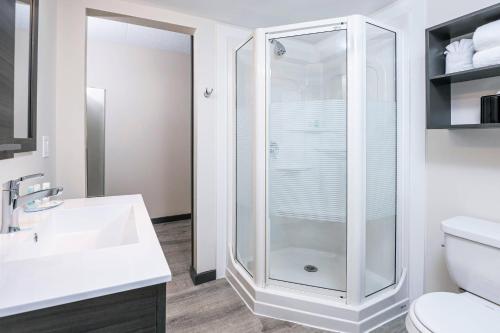 a bathroom with a shower and a sink at Quality Inn & Conference Centre Kingston Central in Kingston
