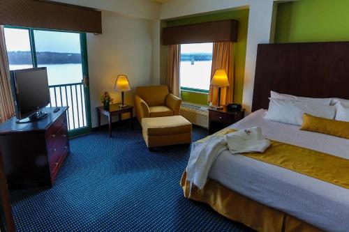 a hotel room with a bed and a chair at Grand Harbor Resort in Dubuque