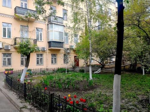 a building with a flower garden in front of it at Home Hotel Apartments on Zoloti Vorota in Kyiv