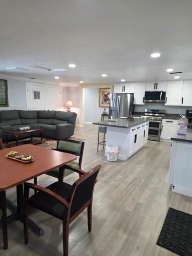 a kitchen and living room with a table and a couch at Cozy SeaTac home in SeaTac