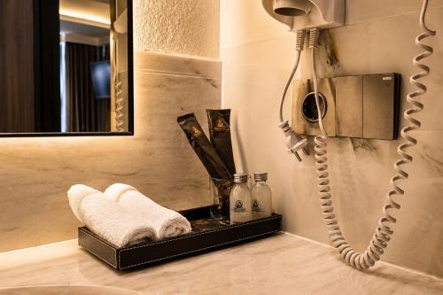 a bathroom with a telephone and a mirror at Arkadewi Boutique Hotel Prawirotaman in Yogyakarta