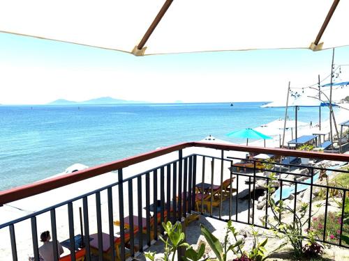 a balcony with a view of the beach and the ocean at Hidden Beach Bungalow Sea View in Hoi An