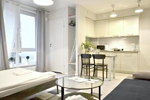 a living room with a couch and a table at Residence Aparthotel in Szczecin