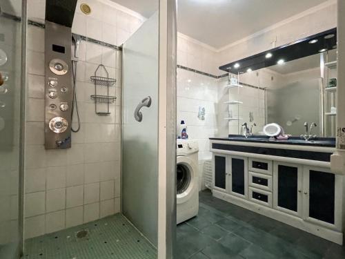 a bathroom with a sink and a washing machine at Baserian in Saint-Pé-de-Léren