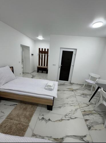 a white room with a bed and a table and chairs at Ametist in Mukacheve