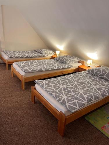 three mattresses in a room with two beds at Apartament de'Lux in Żywiec