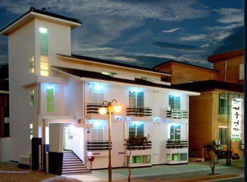 a white building with blue lights on it at Daecheon gyeoulyeonga pension in Boryeong