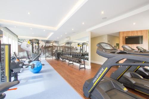 a gym with treadmills and exercise equipment in a building at Hotel Le Canard Lages in Lages