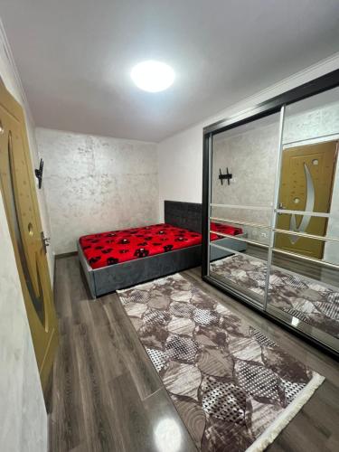 a room with a red bed in a room at Apartamente Giu in Giurgiu