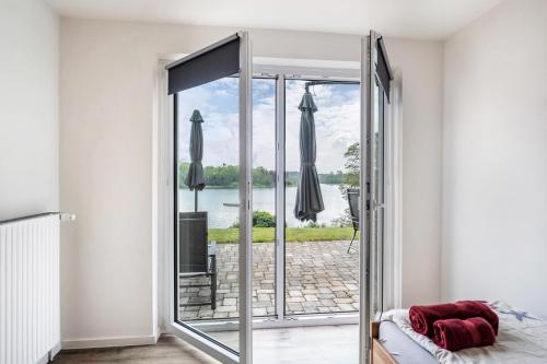 a room with a sliding glass door leading to a patio at Haus am See in Stocksee