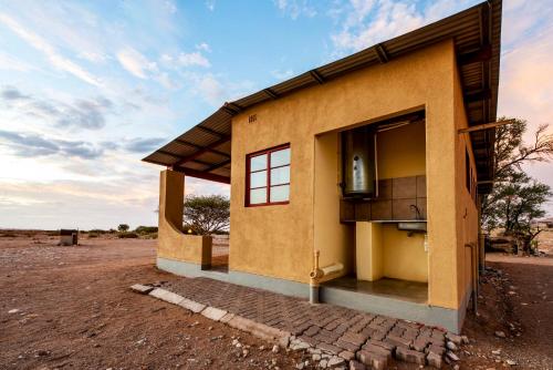 a small building in the middle of the desert at Namib Desert Campsite in Solitaire