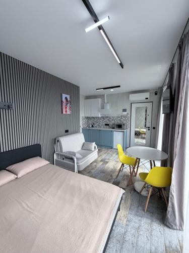 a bedroom with a bed and a table and chairs at Kobuleti Lounge in Kobuleti