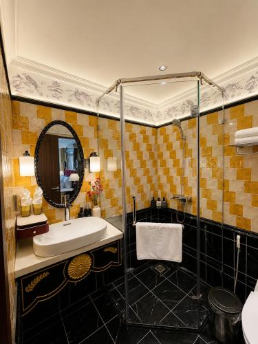 a bathroom with a sink and a shower at Eliana Robusta Hotel in Hanoi