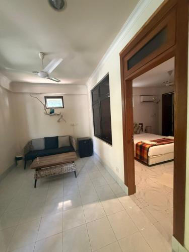 a living room with a couch and a bed at Banana villa in Rasdhoo