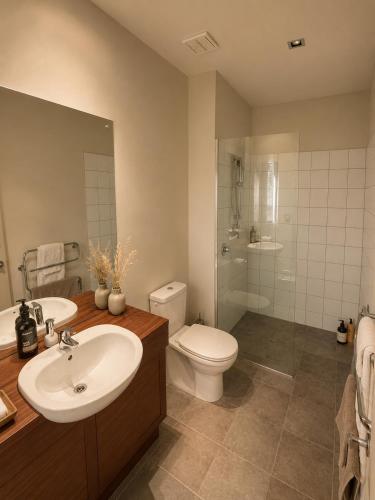 a bathroom with a sink and a toilet and a shower at Best high country retreat - Terrace Downs in Windwhistle