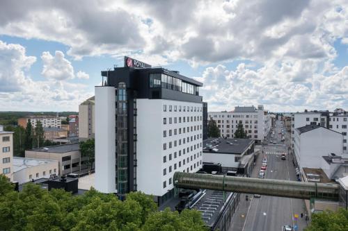 a tall white building with a sign on top of it at Original Sokos Hotel Royal in Vaasa