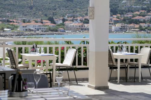 a table and chairs on a balcony with a view at Skopelos Village Hotel in Skopelos Town