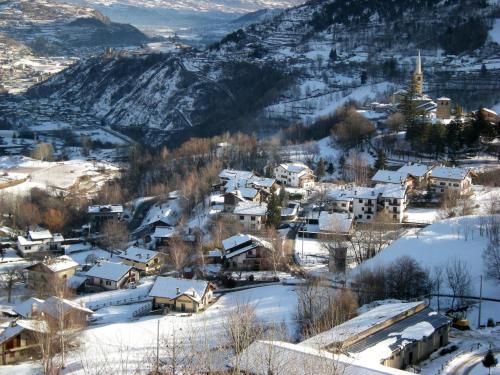 a small town covered in snow with a church at La Pietra Felice in Introd