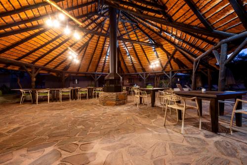 a large room with tables and chairs and lights at Namib Desert Campsite in Solitaire