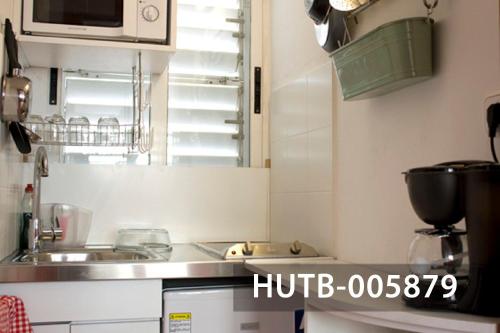 a kitchen with a sink and a microwave at Ghat Apartments Gracia II in Barcelona