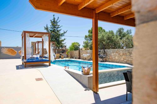 a pool with a gazebo next to a swimming pool at Traounou Serenity Villa Near to Afandou Beach in Afantou