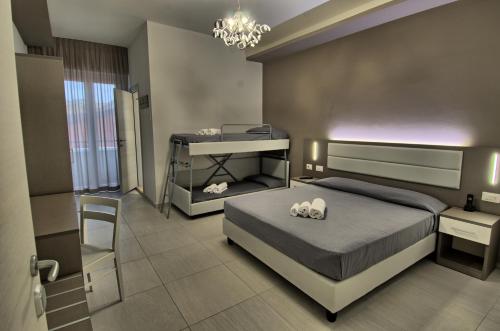 a bedroom with a bed and a table and a desk at GFH - Hotel Sole Resort & Spa in Marotta