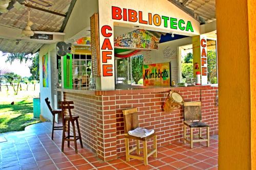 a restaurant with chairs and a sign that reads bulipedia at Hotel - Granja de Animales San Basilio de Palenque in San Basilio del Palenque