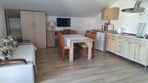a kitchen and dining room with a table and chairs at Villa Alla Bed and Breakfast in Herceg-Novi