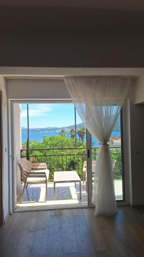 a door to a balcony with a view of the ocean at Villa Alla Bed and Breakfast in Herceg-Novi