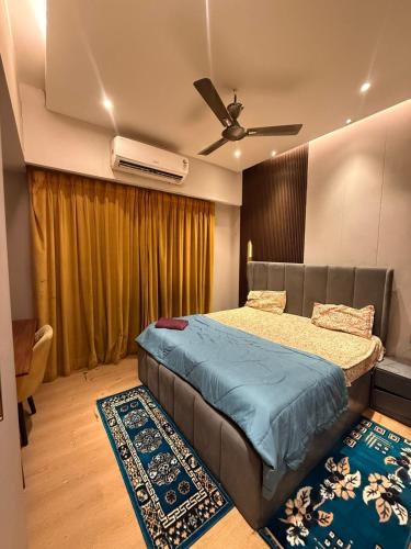 a bedroom with a bed and a ceiling fan at THE MOONLIGHT STUDIo in Ghaziabad