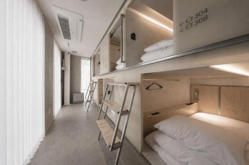 a small room with bunk beds and a ladder at At gangnam seoul in Seoul