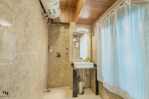 a bathroom with a sink and a mirror at Hotel Hamza in Srinagar