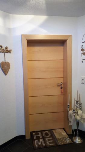 a wooden door in a room with a sink at Haus am Wald in Neustift im Stubaital