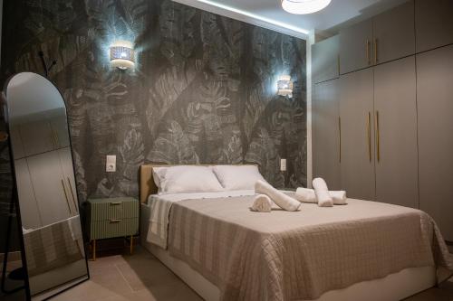 a bedroom with a bed with two towels on it at DNS Elements Apartments 1 in Nea Karvali
