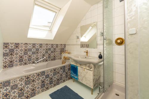 a bathroom with a sink and a tub and a shower at Stadt-Chalet Schladming in Schladming