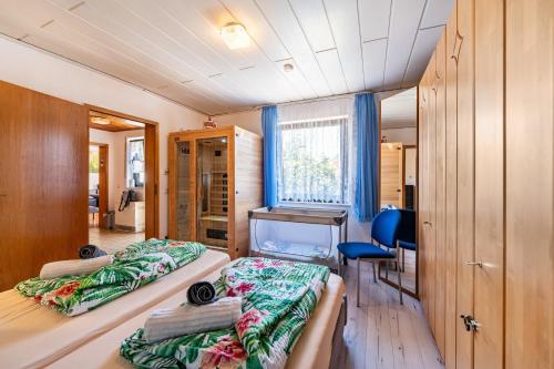 a room with two beds and a desk in it at Ferienhaus Eiffelperle in Kaisersesch