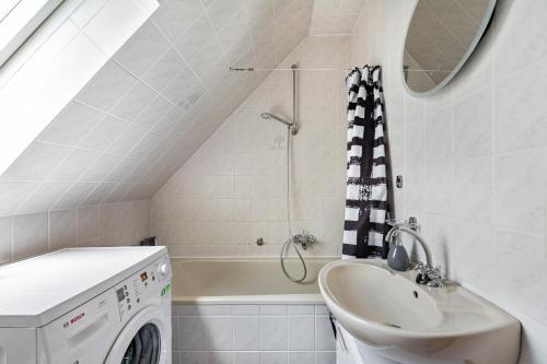 a bathroom with a sink and a washing machine at Ferienhaus Eiffelperle in Kaisersesch