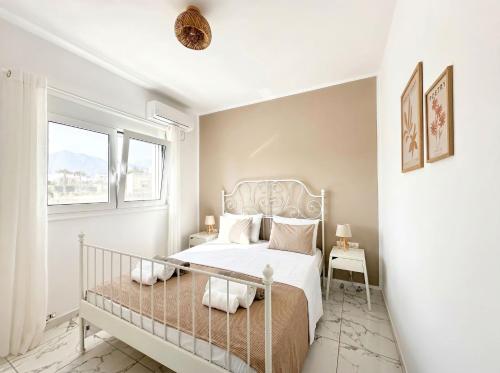 a bedroom with a white bed and a window at Lilu Villa 2 with Private Pool and Seaview in Tigaki