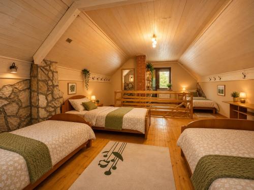 a bedroom with three beds in a room at Biocinovici vikendica in Kolašin