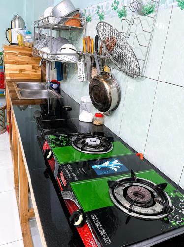 a kitchen with a stove top oven in a kitchen at Cali Homestay Tây Ninh in Tây Ninh